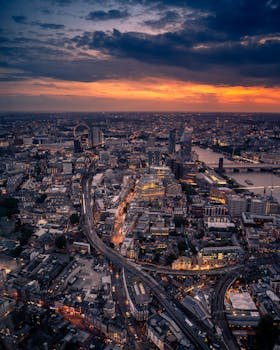 Captivating aerial view of London at twilight with city lights and skyline.