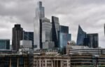 A dramatic view of London's city skyline featuring iconic modern skyscrapers.