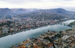 A stunning aerial view of Budapest featuring the Parliament Building and the Danube River.