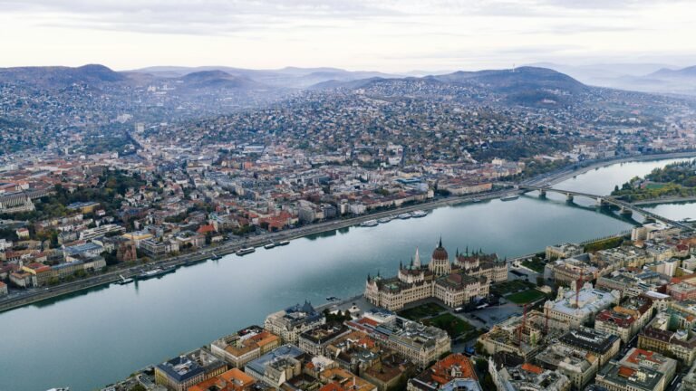 A stunning aerial view of Budapest featuring the Parliament Building and the Danube River.