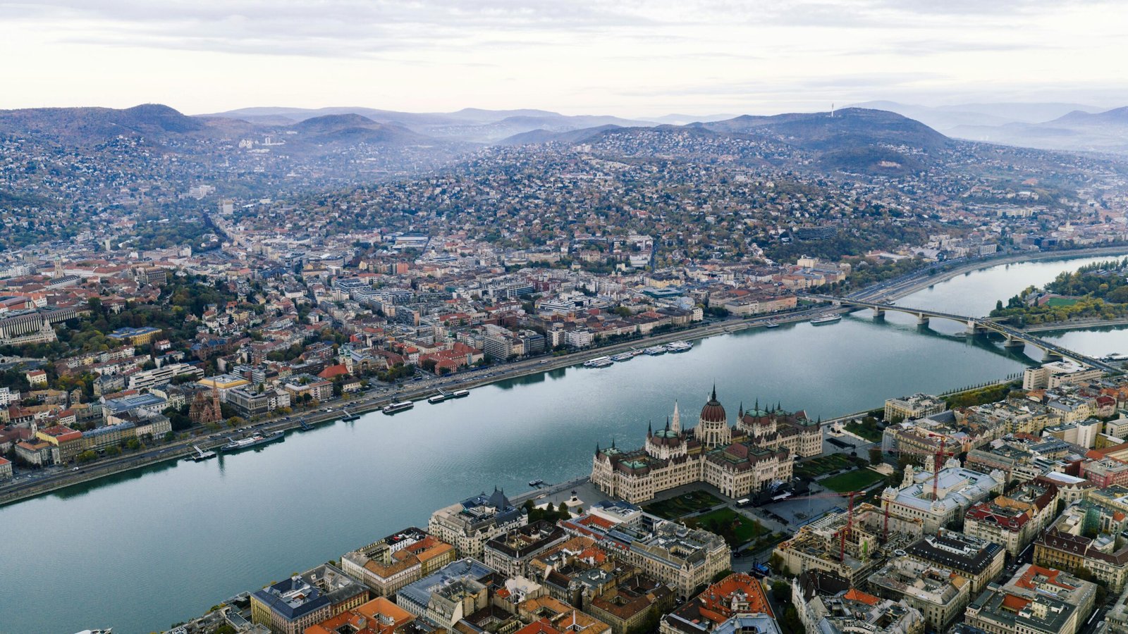 A stunning aerial view of Budapest featuring the Parliament Building and the Danube River.