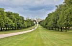 A beautiful summer view of the grand approach to Windsor Castle, surrounded by lush greenery.