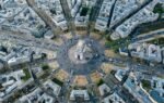 Breathtaking aerial image of Arc de Triomphe nestled within Paris's vibrant cityscape.