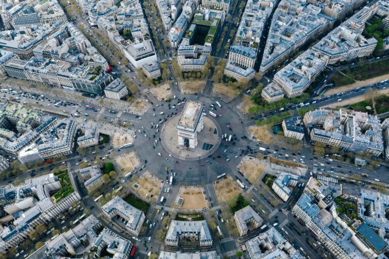 Breathtaking aerial image of Arc de Triomphe nestled within Paris's vibrant cityscape.