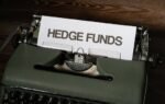Close-up of a vintage typewriter with a paper labeled 'Hedge Funds'.