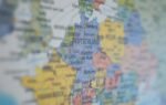 Close-up view of Germany on a colorful world map showing major cities.