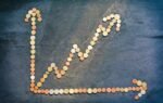 An upward trend graph made from coins representing financial growth and success.