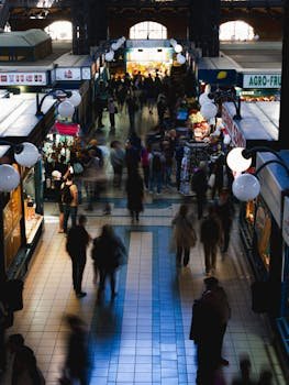 Blurred crowd in Budapest market hall, showcasing vibrant life.