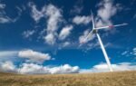 Wind turbines under a vibrant blue sky, showcasing renewable energy in Ordu, Turkey.
